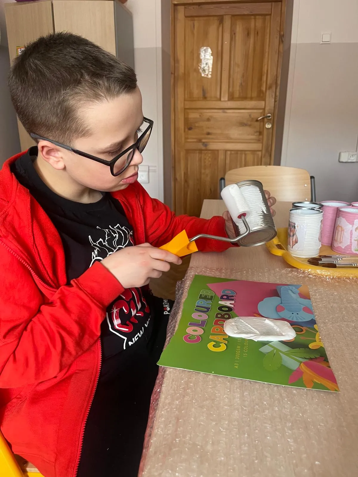 chłopiec maluje puszkę