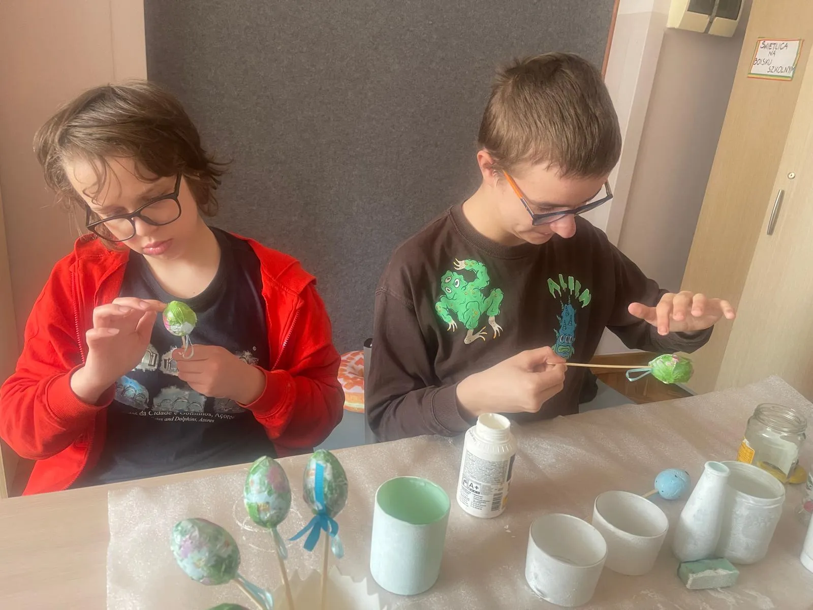 chłopcy malują słoiki